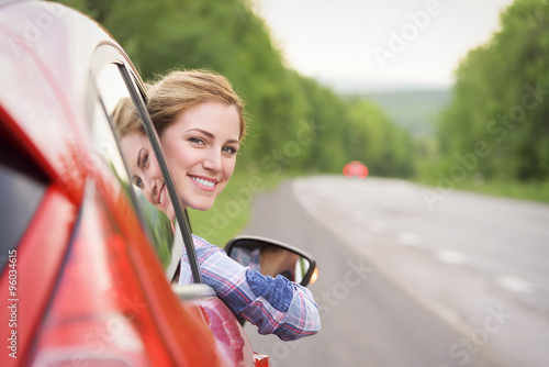 Woman in red car.