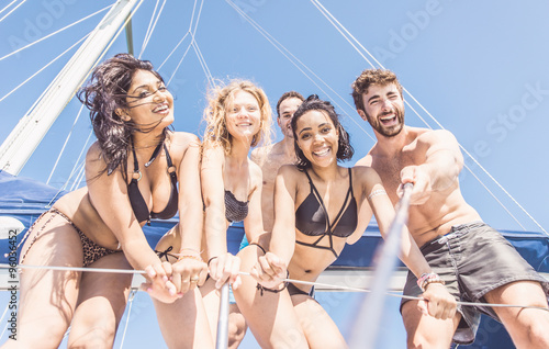 Group of friends taking selfie from the boat