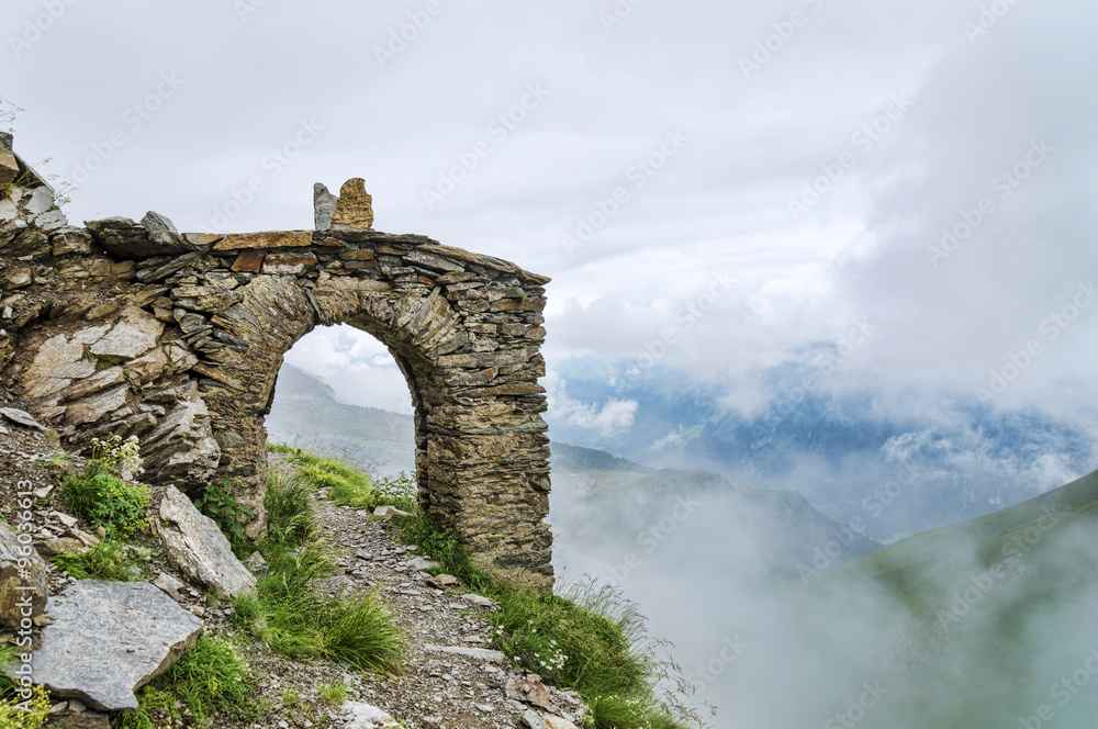 Old arch construction and mountain hiking path going through