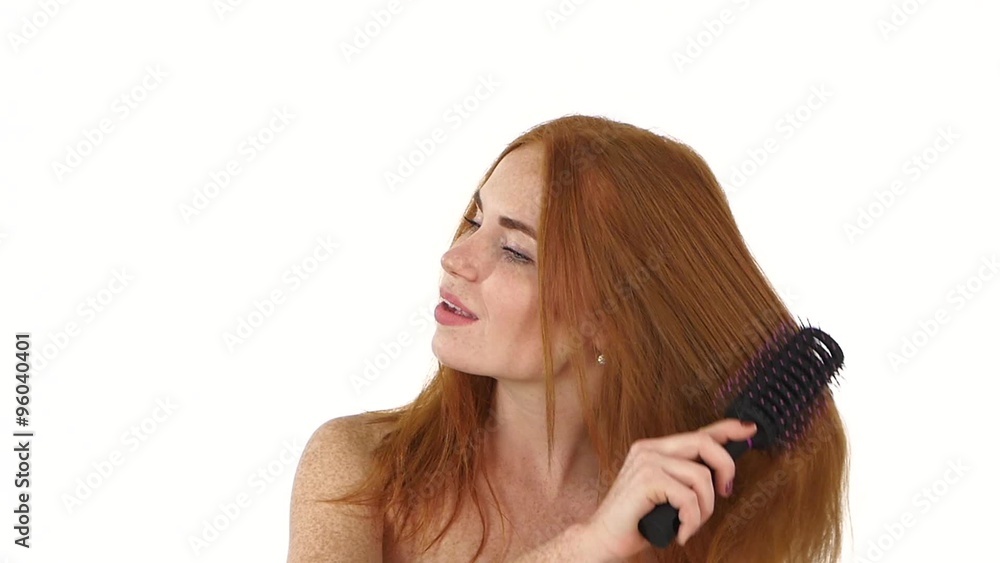 Beautiful Redhead girl Brushing Her Hair. slow motion, close up, bathroom Beautiful Redhead girl Brushing Her Hair. slow motion, close up, bathroom