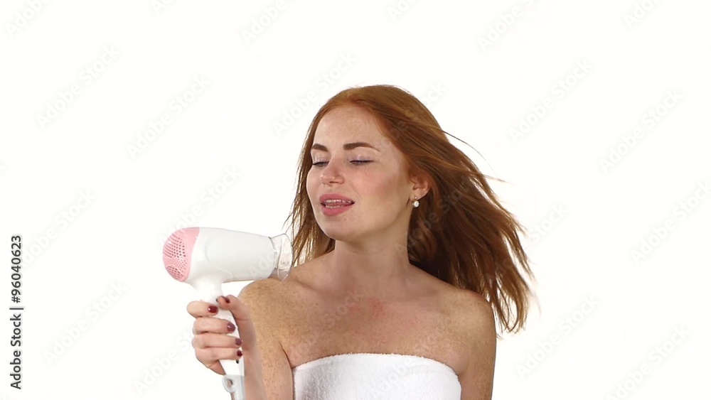 Smiling young Redhead girl singing white hair dryer. slow motion, bathroom Smiling young Redhead girl singing white hair dryer. slow motion, bathroom