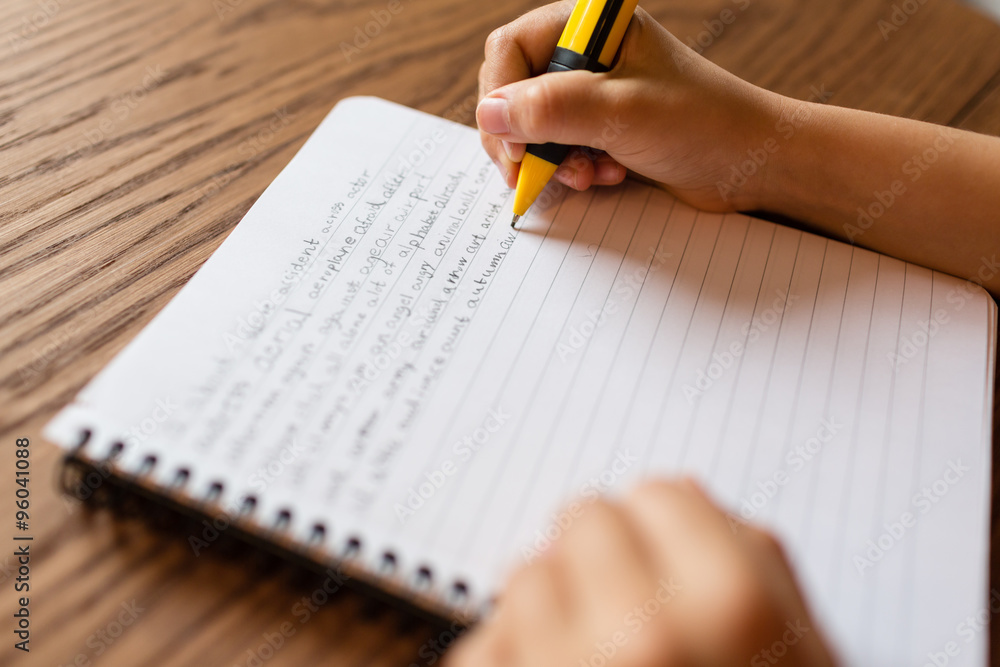 Person writing by hand on notepad Stock Photo | Adobe Stock