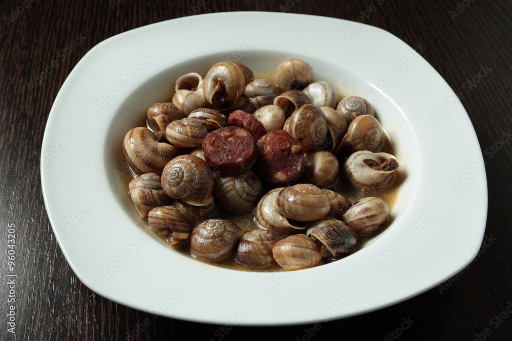 white dish with snails cooked in sauce white dish with snails cooked in sauce