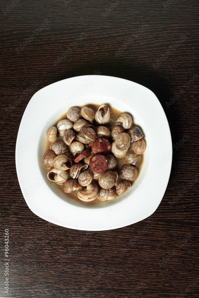 white dish with snails cooked in sauce white dish with snails cooked in sauce