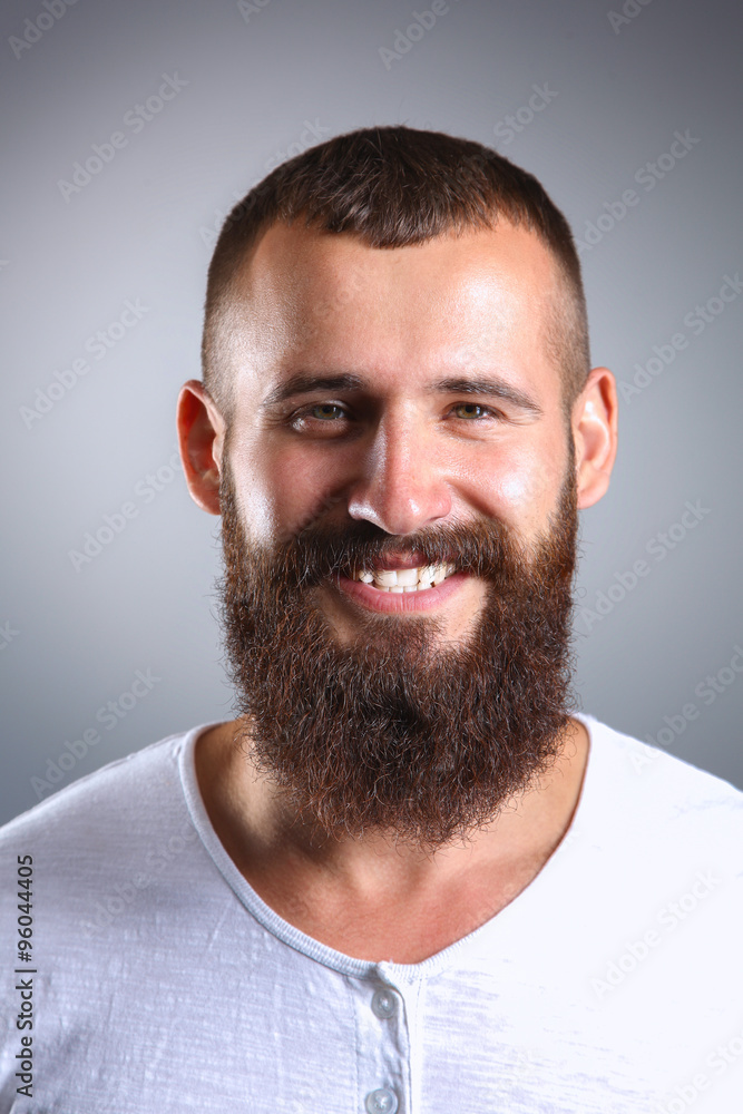 Portrait of handsome man standing, isolated on grey background Portrait of handsome man standing, isolated on grey background