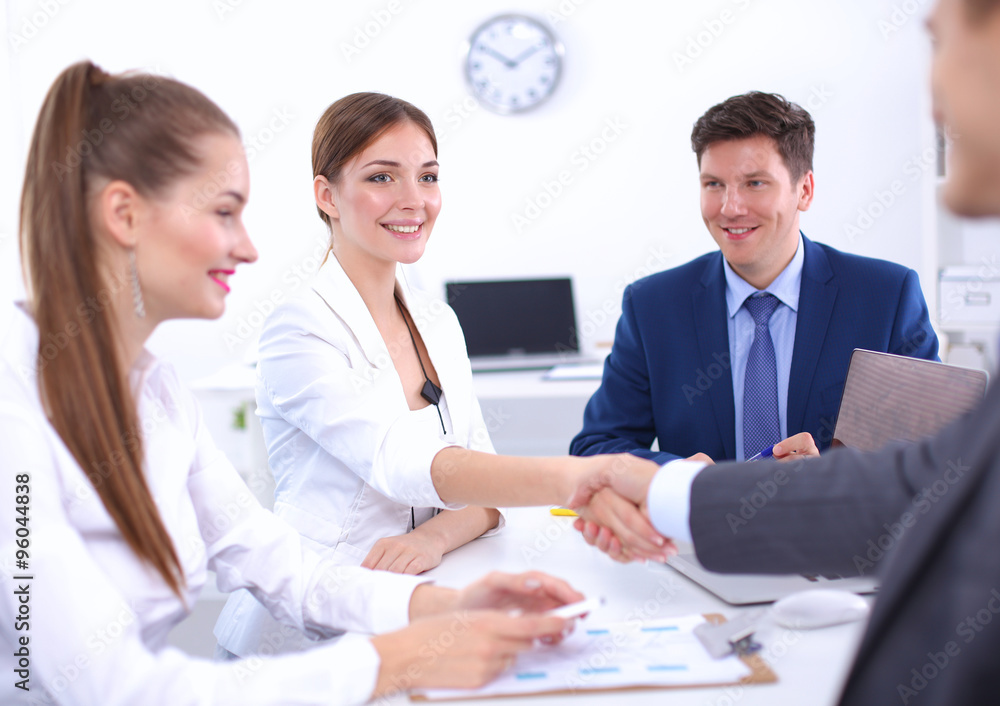 Business people shaking hands, finishing up a meeting Business people shaking hands, finishing up a meeting