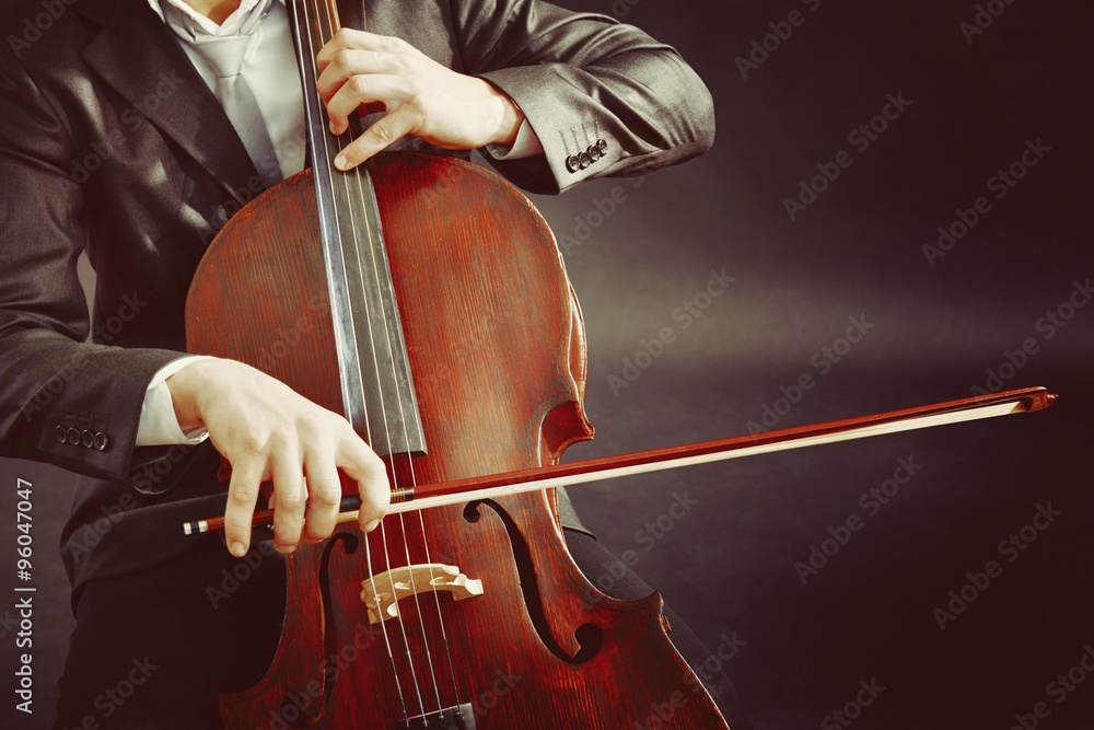 Man playing on cello on dark background Man playing on cello on dark background