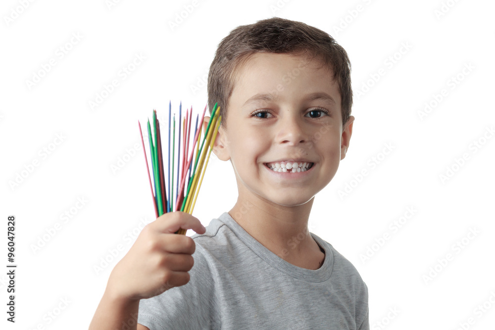 Cheerful child playing mikado isolated on white background