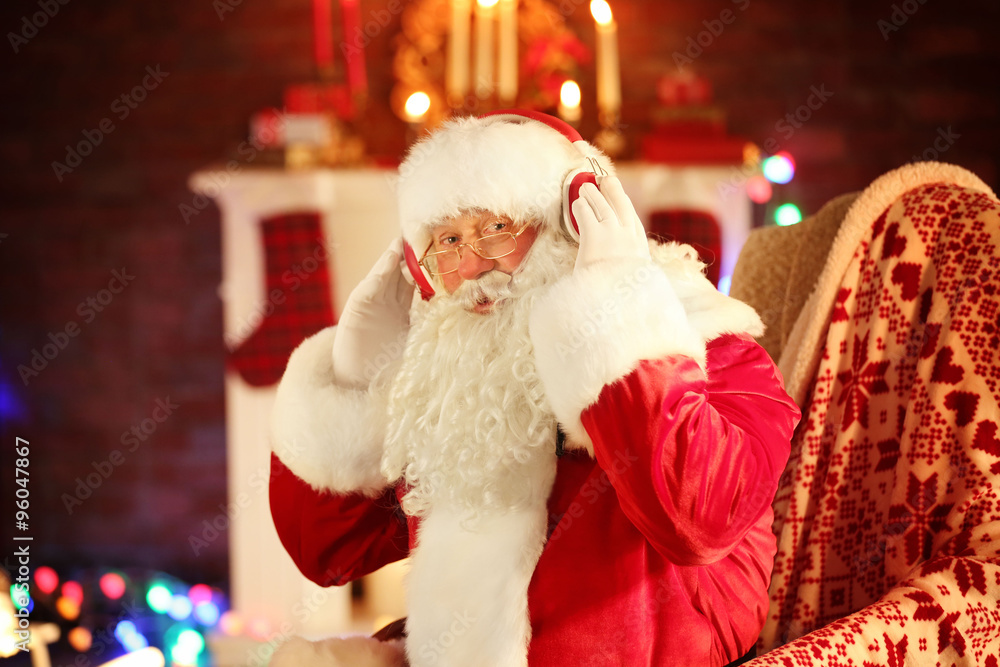 Santa Claus sitting with headphones sitting in comfortable rocking chair at home Santa Claus sitting with headphones sitting in comfortable rocking chair at home