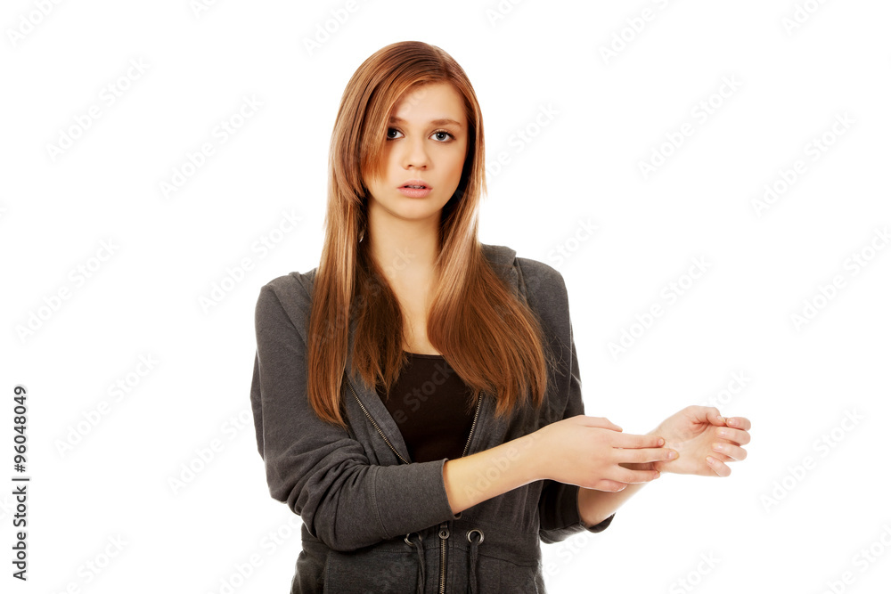 Teenage woman holding her wrist - pain concept Teenage woman holding her wrist - pain concept