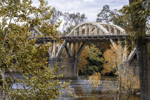 Bridge over a river with fall foliage photo