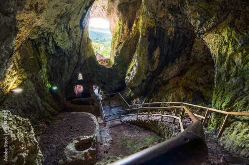 Cave Interior with Stone Staircase of Predjama Castle in Slovenia. Famous European Tourist Place. photo