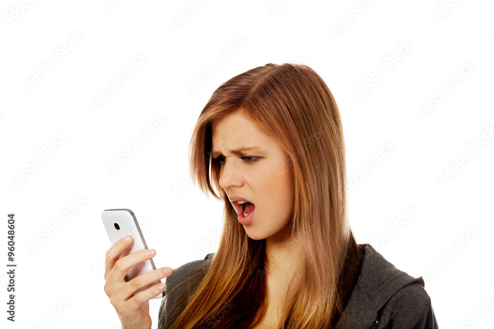 Teenage woman screaming to the phone Teenage woman screaming to the phone