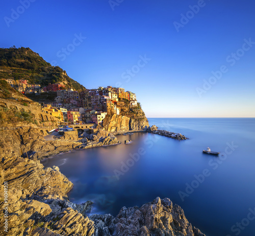 Manarola village, rocks and sea at sunset. Cinque Terre, Italy