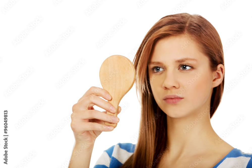 Teenage beautiful woman looking in a mirror Teenage beautiful woman looking in a mirror