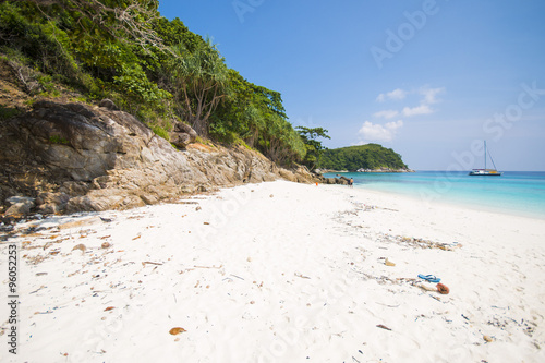 tropical beach with calm blue sea surf