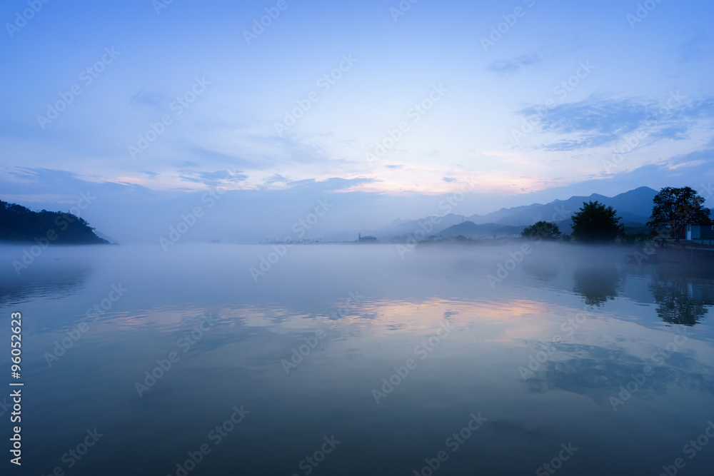lake, hill and reflection in fog