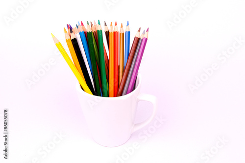 Color pencils in white mug on white background