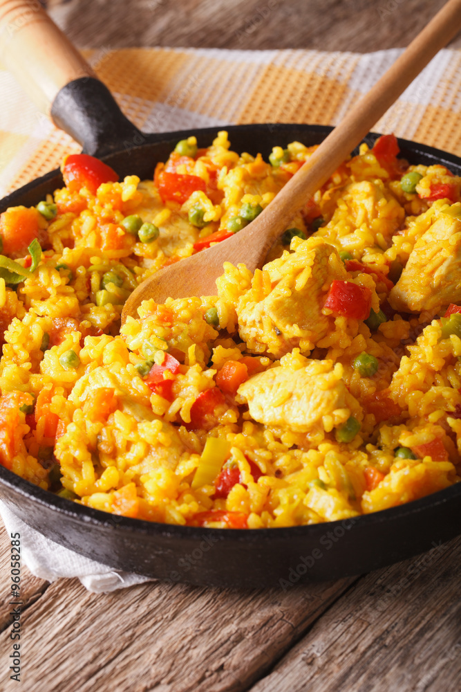 Hispanic rice with chicken and vegetables close-up in a pan. vertical
Hispanic rice with chicken and vegetables close-up in a pan. vertical