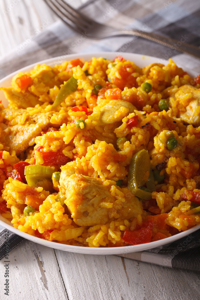 Rice with chicken and vegetables close up in a bowl. vertical
Rice with chicken and vegetables close up in a bowl. vertical