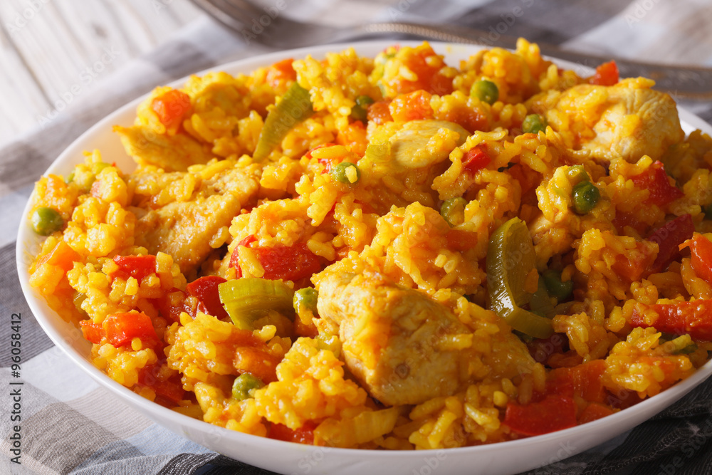 Rice with chicken and vegetables in a bowl macro. horizontal Rice with chicken and vegetables in a bowl macro. horizontal