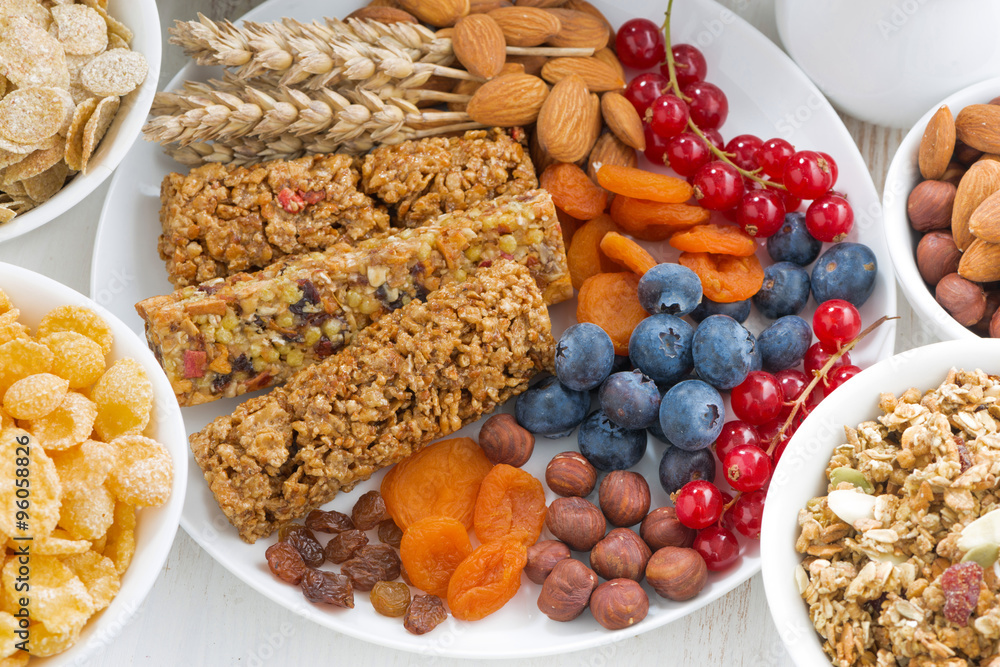 assortment of cereal muesli bars, fresh and dried fruit 