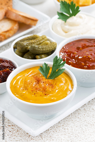 assortment sauces and snacks, vertical, closeup