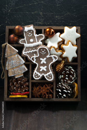 Christmas symbols in a wooden box on dark wooden background © cook_inspire