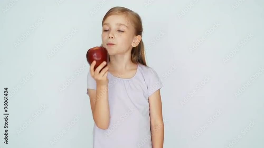 Girl sniffing and kissing apple and laughing. Thumb up. Ok Girl sniffing and kissing apple and laughing. Thumb up. Ok