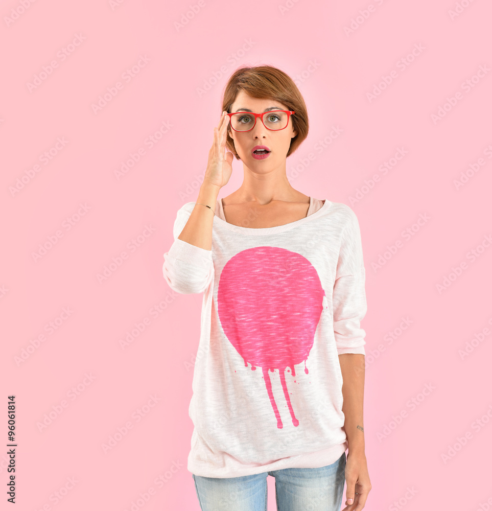 Smiling trendy girl with red glasses, pink background Smiling trendy girl with red glasses, pink background