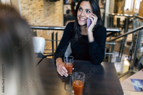 Beautiful brunette talking on phone in cafe © NDABCREATIVITY