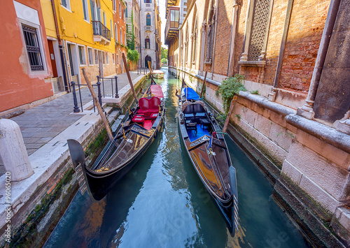 two gondolas in narrow canal in Venice. Italy.