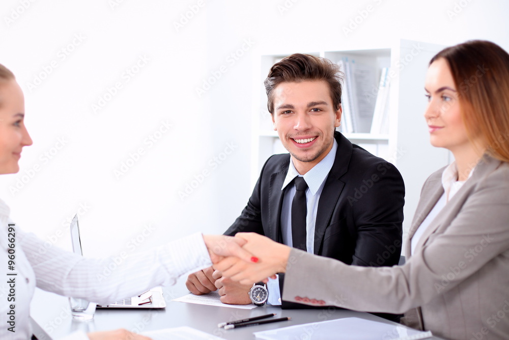 Business people shaking hands, finishing up a meeting. Copy space at the left corner Business people shaking hands, finishing up a meeting. Copy space at the left corner
