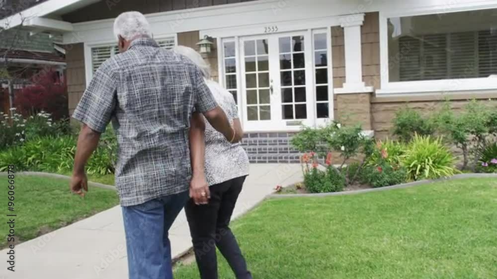 Senior black couple walk into new home Senior black couple walk into new home