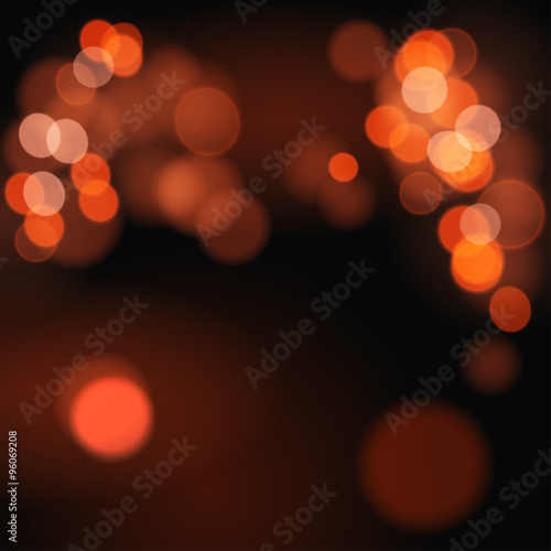 Abstract background with orange bokeh defocused lights.