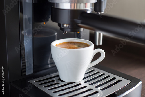 Brewing tasty espresso with coffee machine.