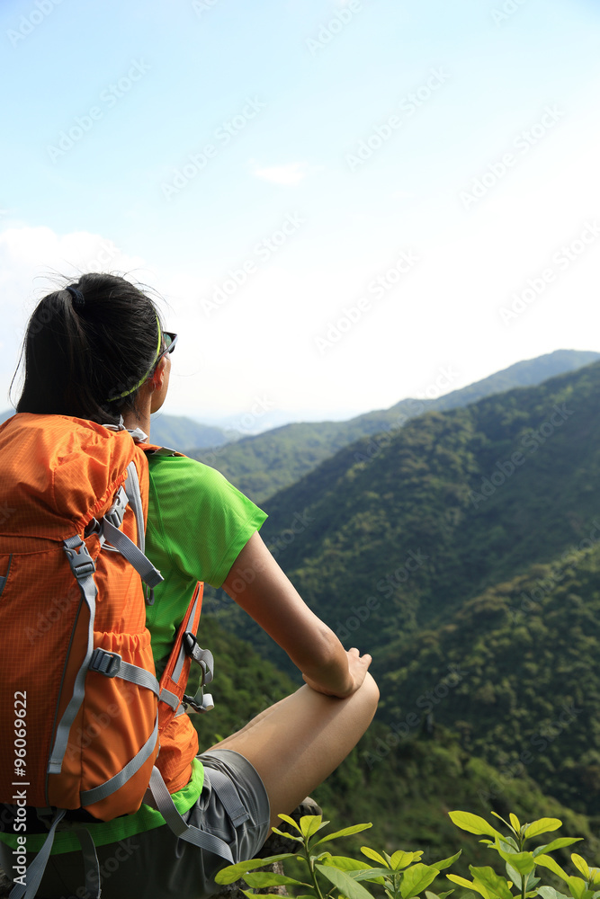 woman backpacker enjoy the view at mountain peak cliff woman backpacker enjoy the view at mountain peak cliff
