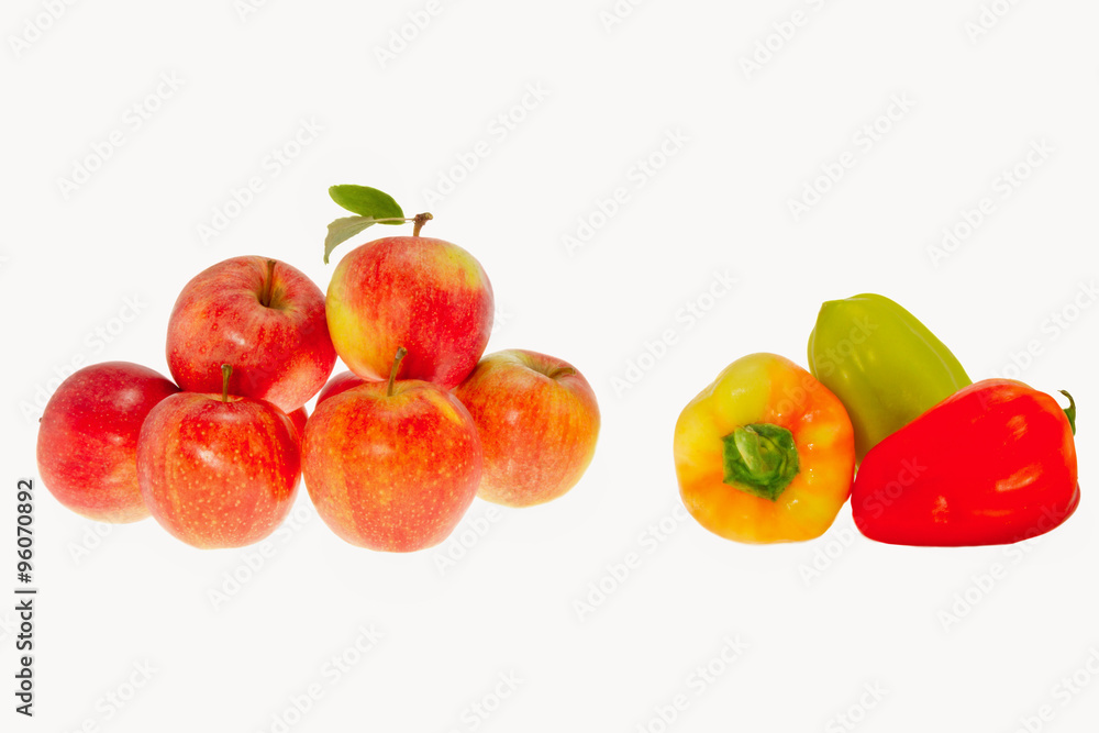 Red ripe apples and sweet pepper on a white background