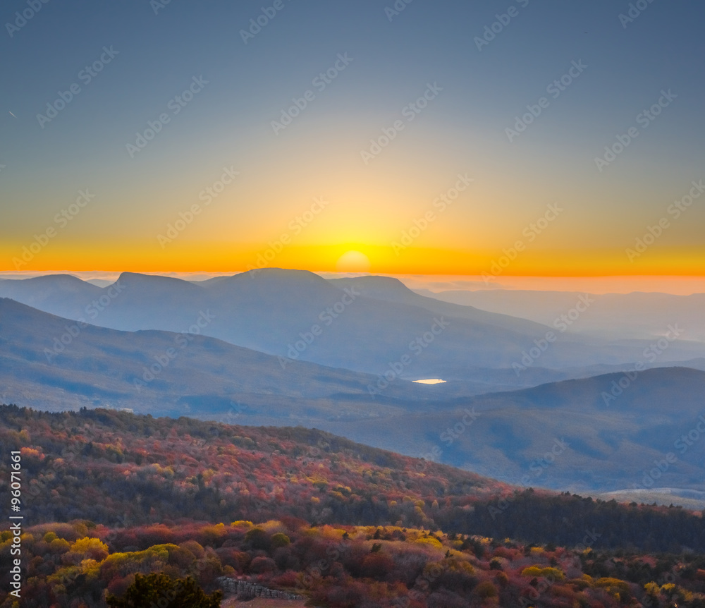 quiet sunset over a misty mountain