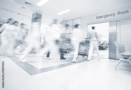 A motion blurred photograph of a patient on stretcher or gurney