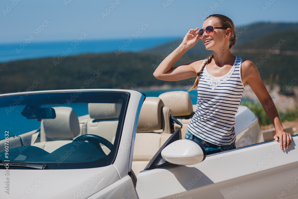 Beautiful woman in a white convertible car.