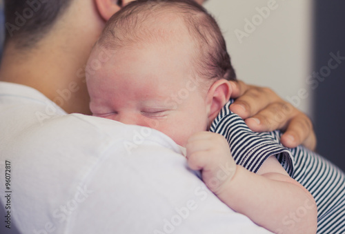 Father holding newborn baby.