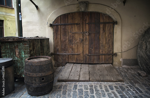 Old rusty wooden gate with barrel as a background © katrin_timoff