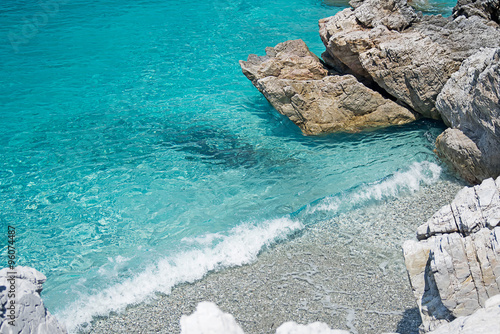 Obraz na płótnie Clear Turquoise Sea Water, Stones and Wave. Greece. w salonie