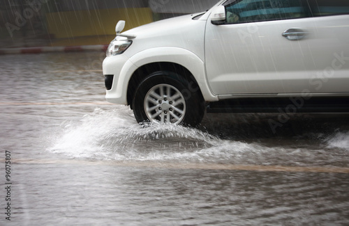 Splash by a car through flood water after hard rain,blurry movement