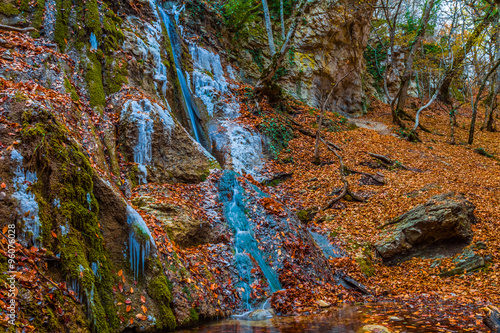 Fototapeta Naklejka Na Ścianę i Meble -  small frozen mountain waterfall