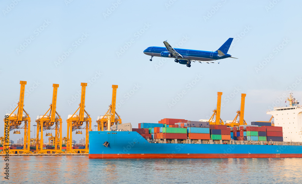 Container cargo freight ship with working crane loading bridge
