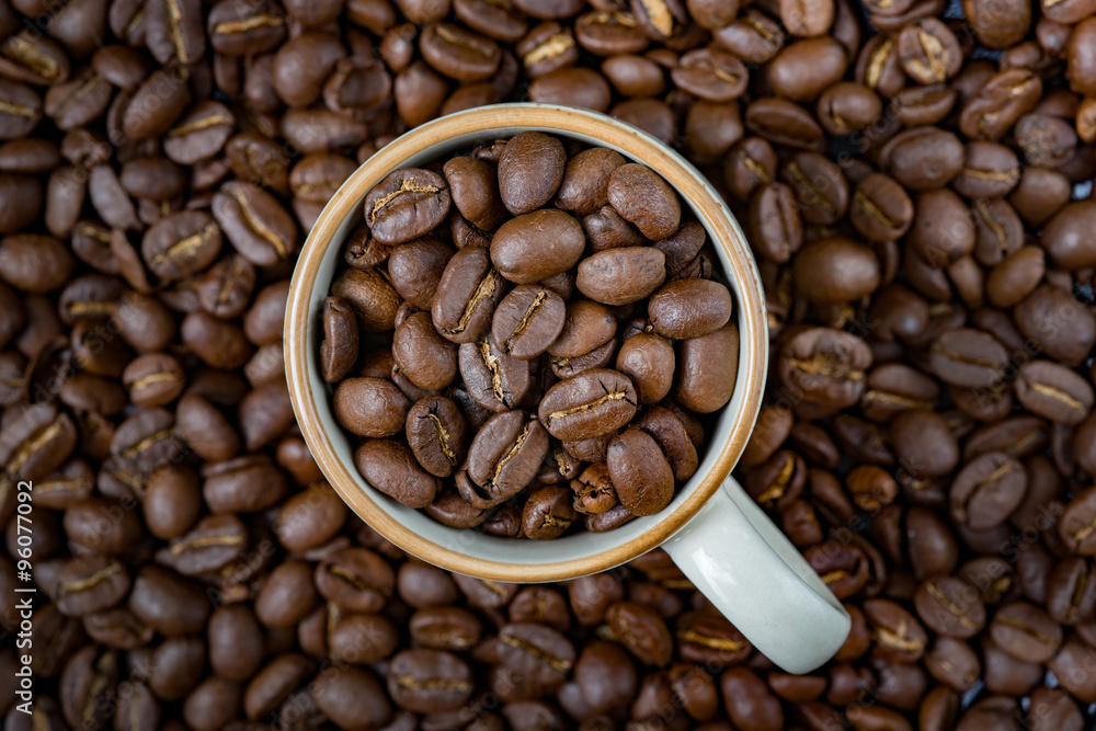 Coffee beans(Arabica) roasted in a cup and background. Coffee beans(Arabica) roasted in a cup and background.
