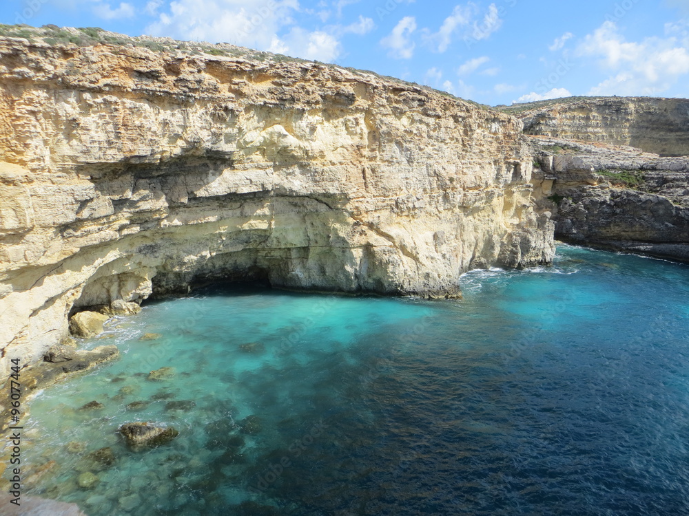Blue lagoon with yellow rocks / Seascape of blue lagoon with yellow rocks on Gozo island