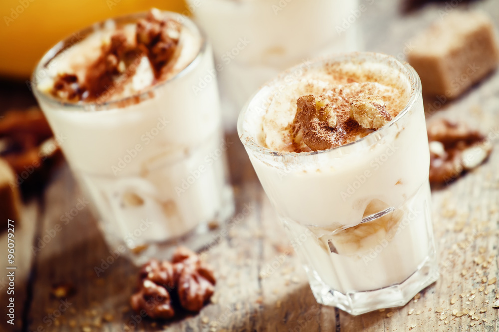 Fresh homemade dessert of bananas, yogurt and nuts, selective fo Fresh homemade dessert of bananas, yogurt and nuts, selective fo
